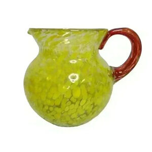 Hand-blown glass water pitcher yellow bubbles red handle.
